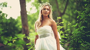 woman wearing white sweetheart bridal gown near plants and trees fashion photography